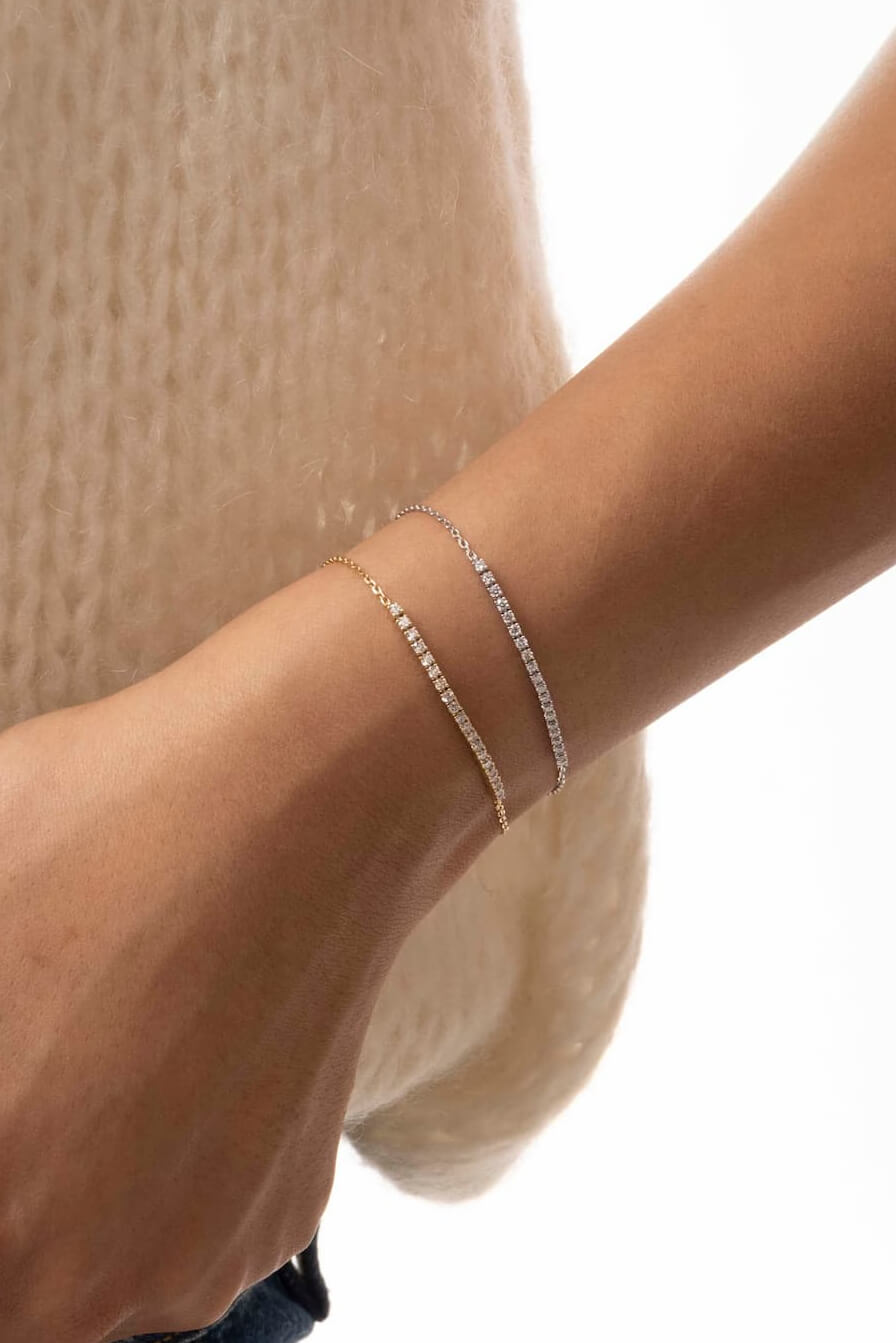 Aurea diamond smile bracelets in solid yellow and white gold stacked for everyday wear, by Anaté fine jewelry