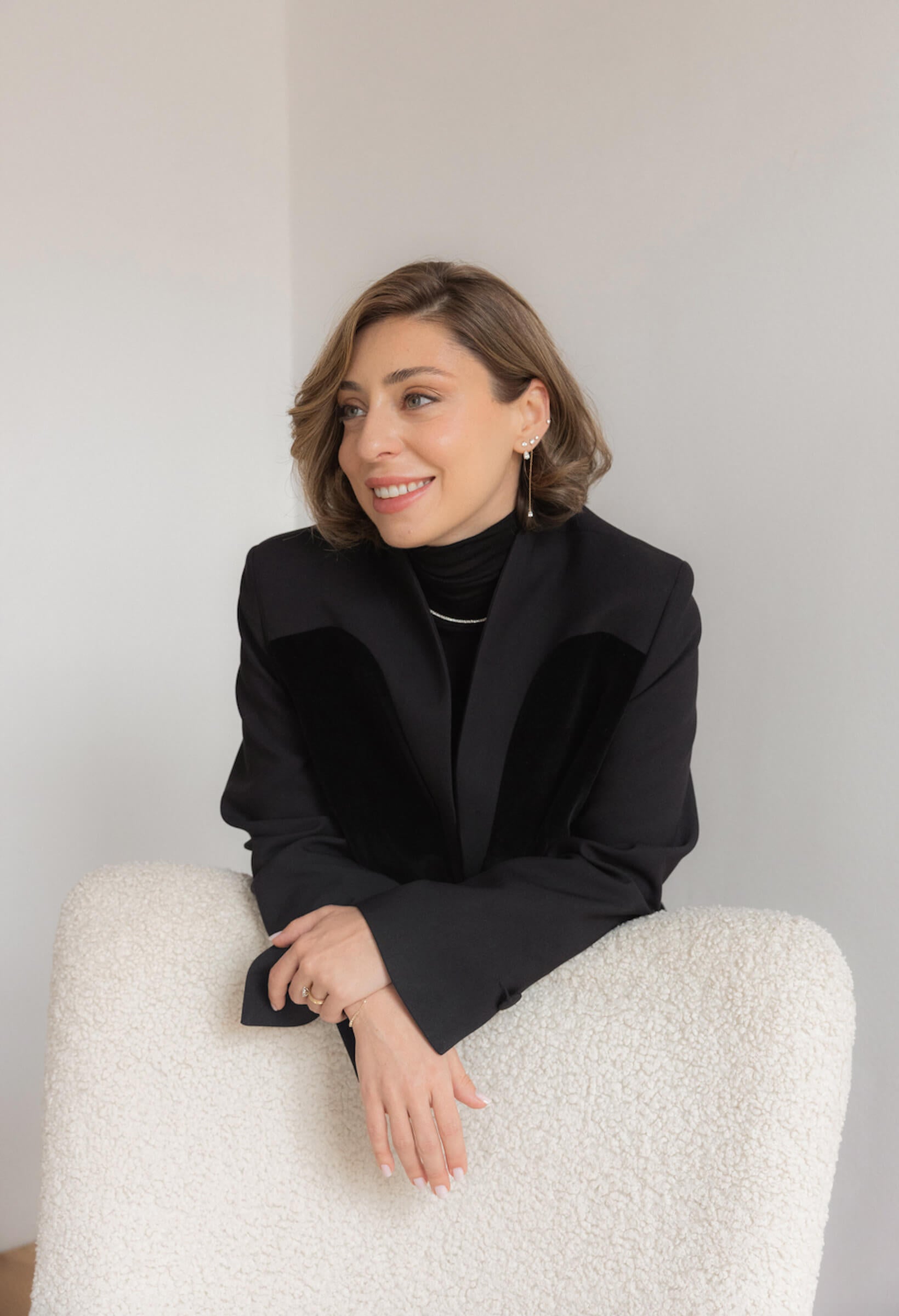 Meet Ana, the founder of Anaté — smiling portrait wearing her own fine diamond jewelry collection