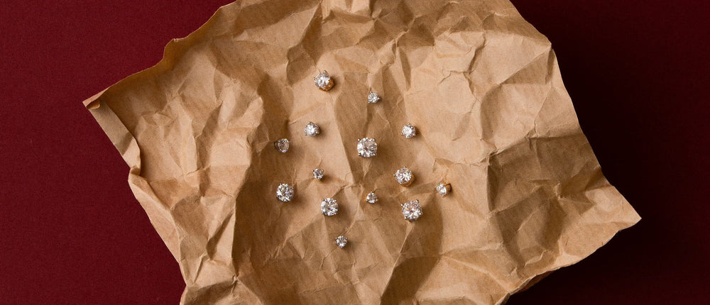Astra round diamond stud earrings on kraft paper — Anate's fairest price, materials over markup