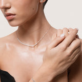 Model wearing the Aurea diamond smile bracelet in solid white gold by Anate, worn on model, portrait shot