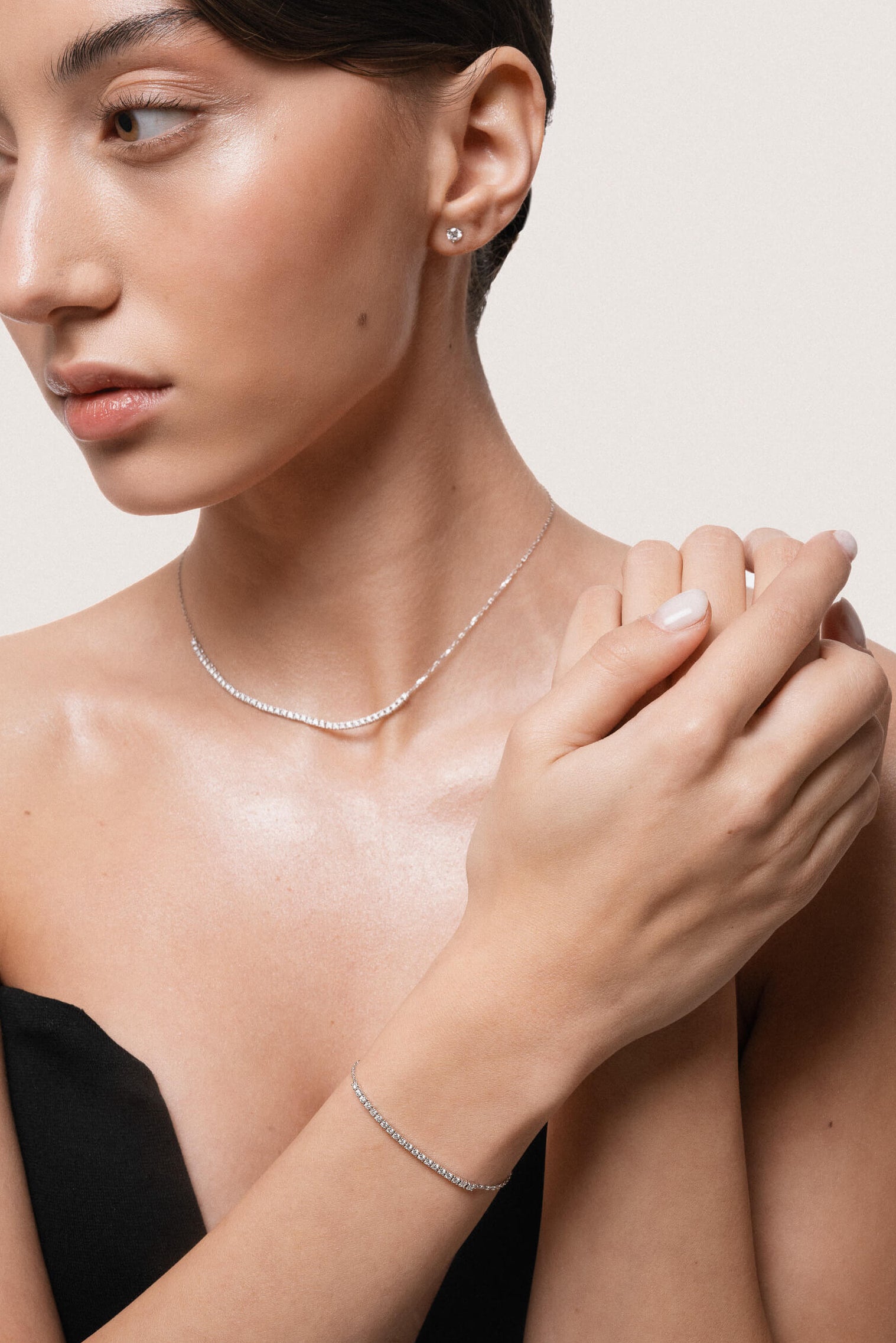 Model wearing the Aurea diamond smile bracelet in solid white gold by Anate, worn on model, portrait shot