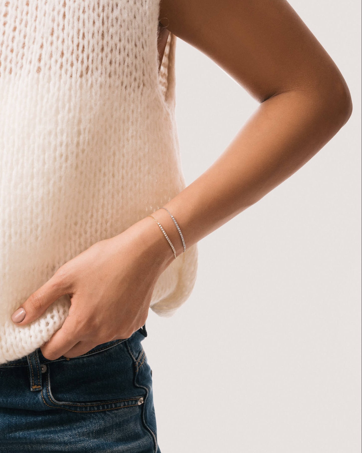 Model wearing the Aurea diamond smile bracelet in solid white gold by Anate, worn on wrist
