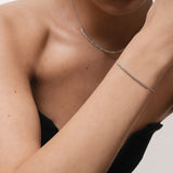 Model wearing the Aurea diamond smile bracelet in solid white gold by Anate, worn on wrist
