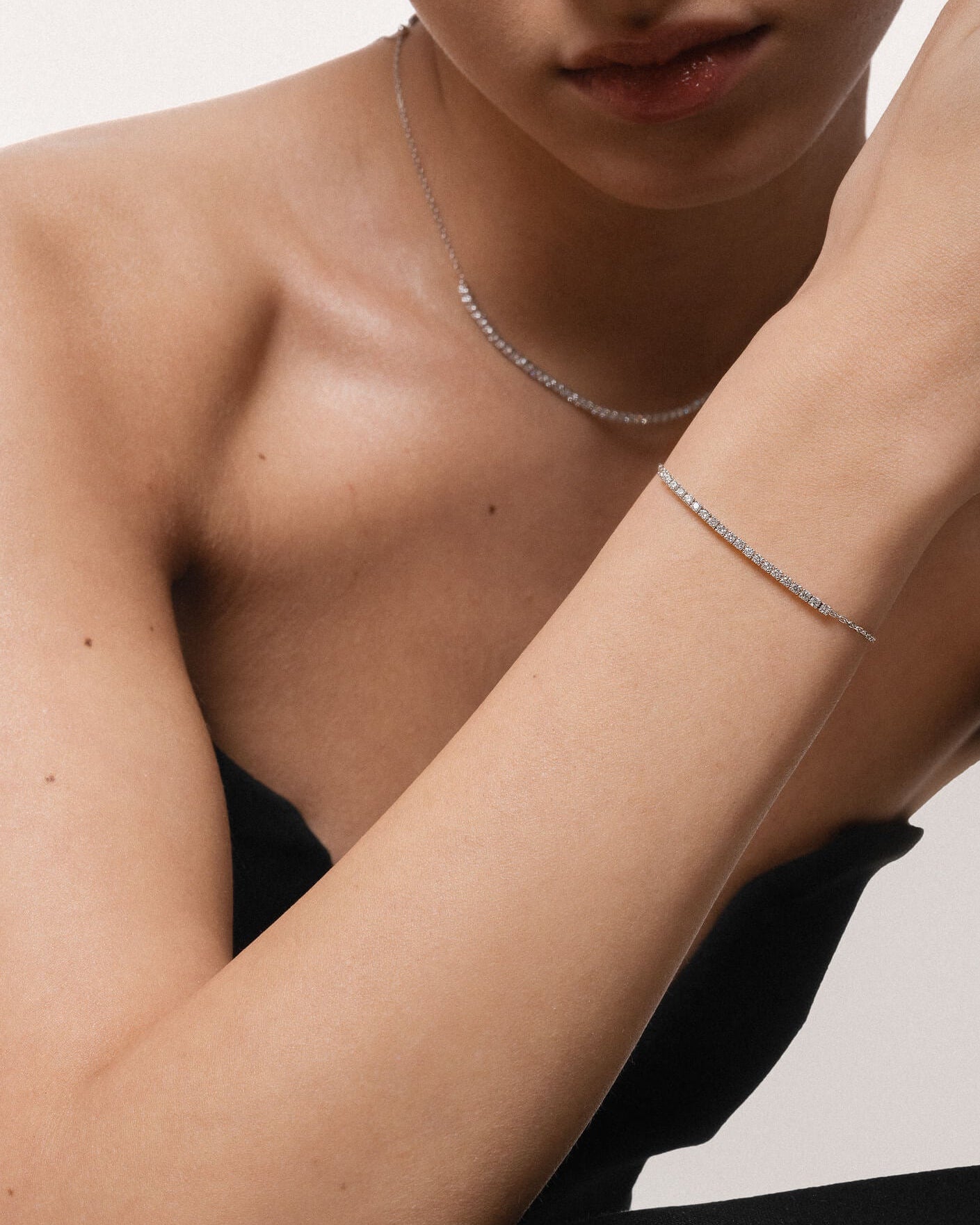 Model wearing the Aurea diamond smile bracelet in solid white gold by Anate, worn on wrist