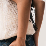 Model wearing the Aurea diamond smile bracelet in solid yellow gold by Anate, worn on wrist