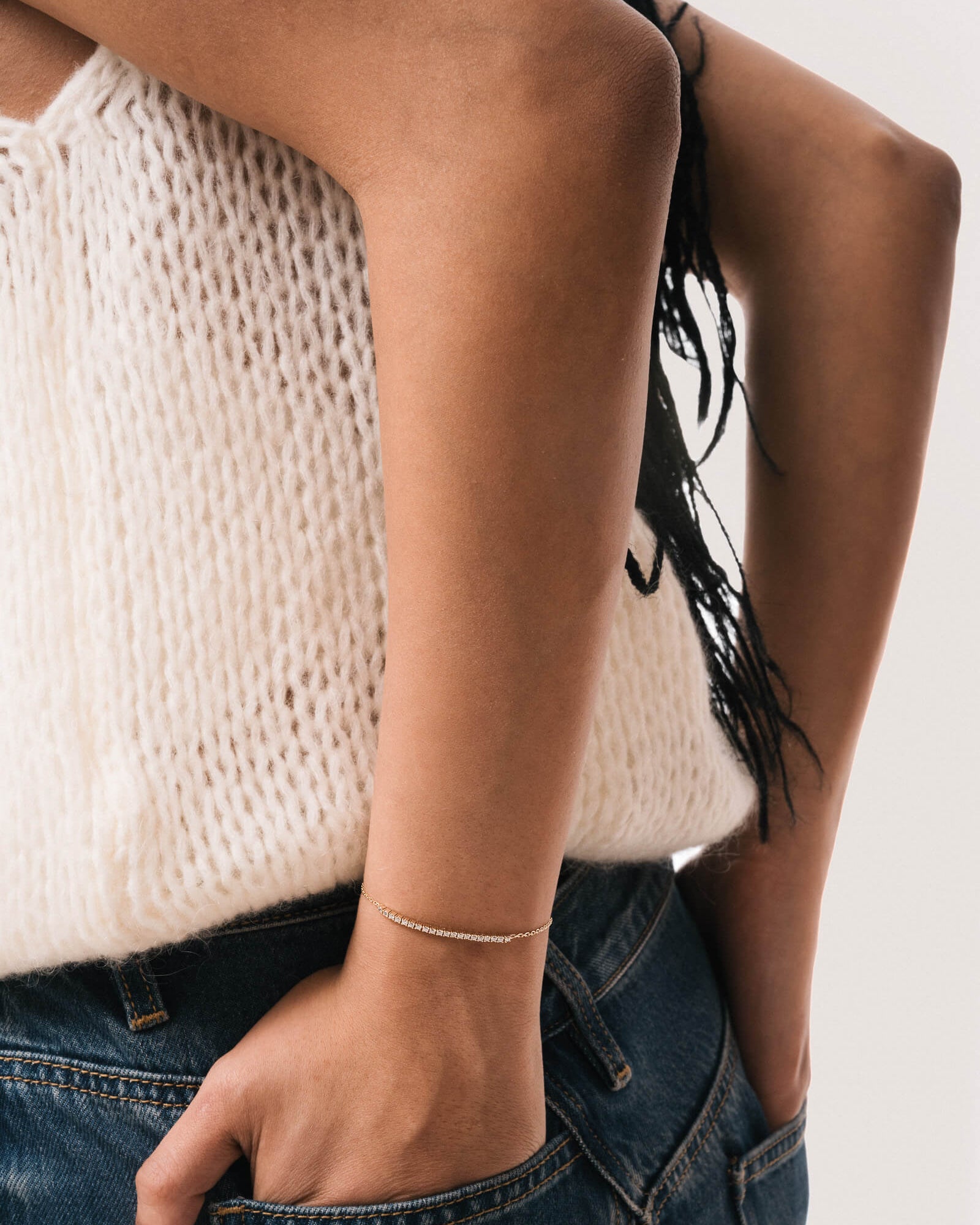 Model wearing the Aurea diamond smile bracelet in solid yellow gold by Anate, worn on wrist