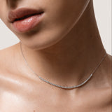 Model wearing the Solea diamond smile necklace in solid white gold by Anate, worn on neck