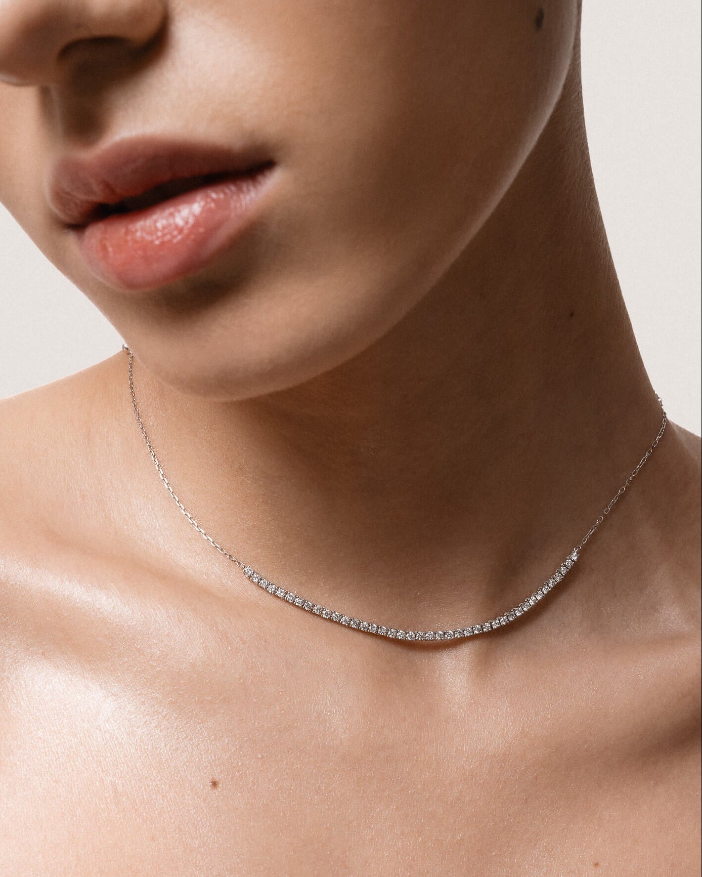 Model wearing the Solea diamond smile necklace in solid white gold by Anate, worn on neck