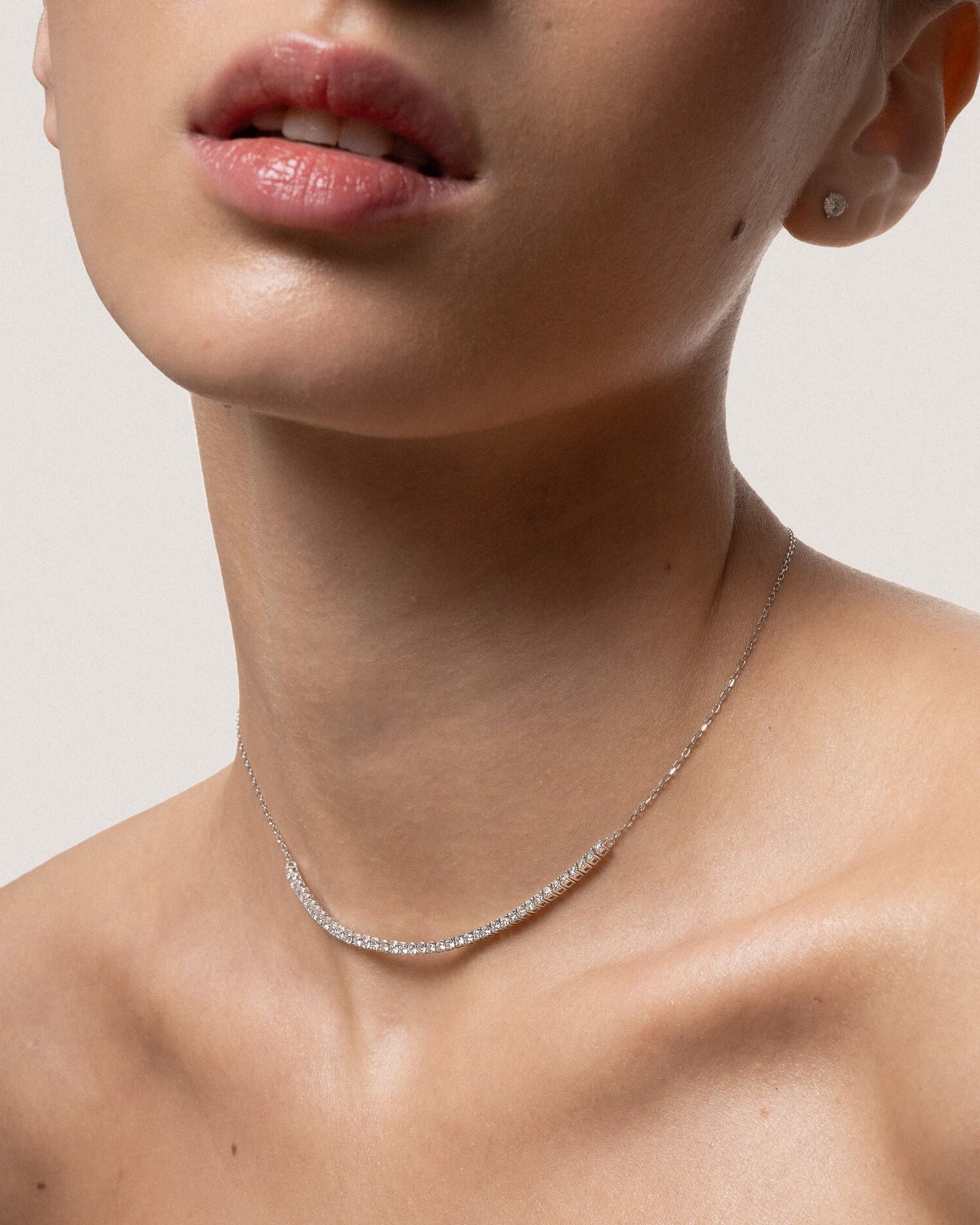 Model wearing the Solea diamond smile necklace in solid white gold by Anate, worn on neck