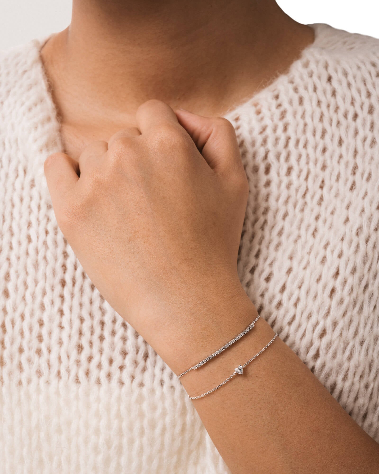 Model wearing the Mara heart diamond bracelet in solid white gold by Anate, worn on wrist