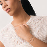 Model wearing the Mara heart diamond bracelet in solid white gold by Anate, worn on wrist