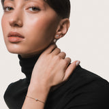 Model wearing the Mara heart diamond bracelet in solid yellow gold by Anate, worn on model, portrait shot