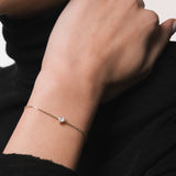 Model wearing the Mara heart diamond bracelet in solid yellow gold by Anate, worn on wrist