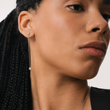 Model wearing the Raya heart diamond drop earrings in solid white gold by Anate, worn on ear