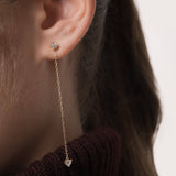 Model wearing the Raya heart diamond drop earrings in solid yellow gold by Anate, worn on ear