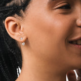 Model wearing the Nia heart diamond ear jacket earrings in solid white gold by Anate, worn on ear variant--0.50ct