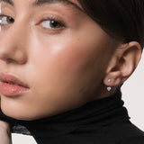 Model wearing the Nia heart diamond ear jacket earrings in solid white gold by Anate, worn on ear variant--0.25ct