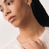 Model wearing the Nia heart diamond ear jacket earrings in solid white gold by Anate, worn on ear variant--0.50ct