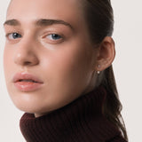 Model wearing the Nia heart diamond ear jacket earrings in solid yellow gold by Anate, worn on ear variant--0.25ct