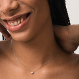 Model wearing the Lumi heart diamond pendant in solid white gold by Anate, worn on model, close-up