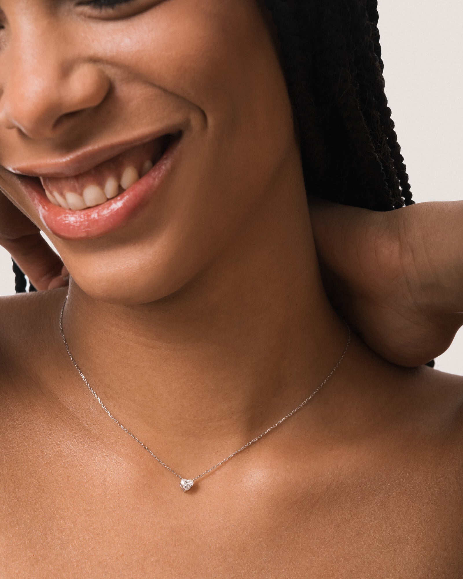 Model wearing the Lumi heart diamond pendant in solid white gold by Anate, worn on model, close-up