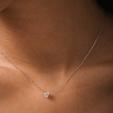 Model wearing the Lumi heart diamond pendant in solid white gold by Anate, worn on model, close-up