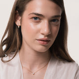 Model wearing the Lumi heart diamond pendant in solid yellow gold by Anate, worn on neck
