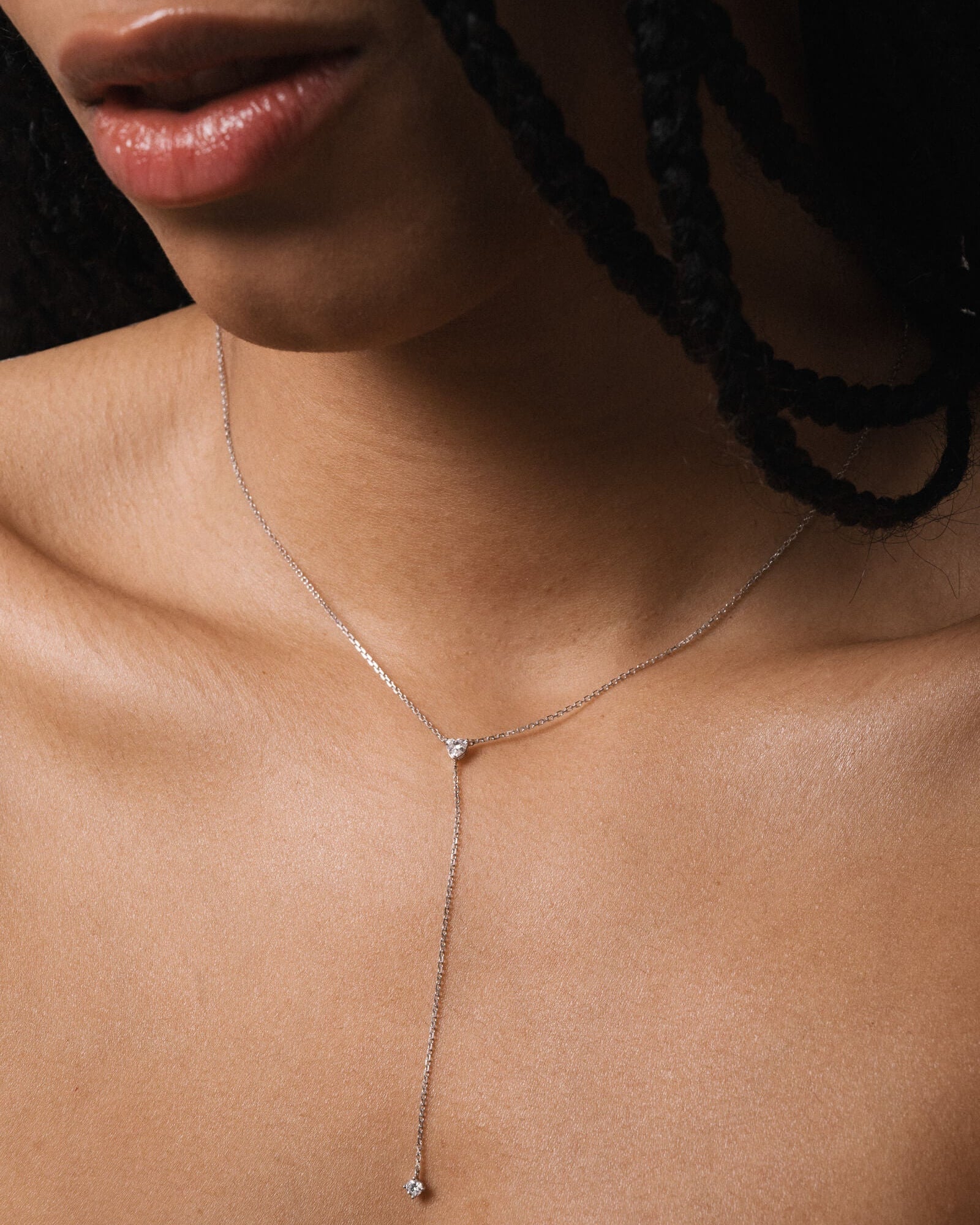 Model wearing the Amara heart diamond tie necklace in solid white gold by Anate, worn on model, close-up