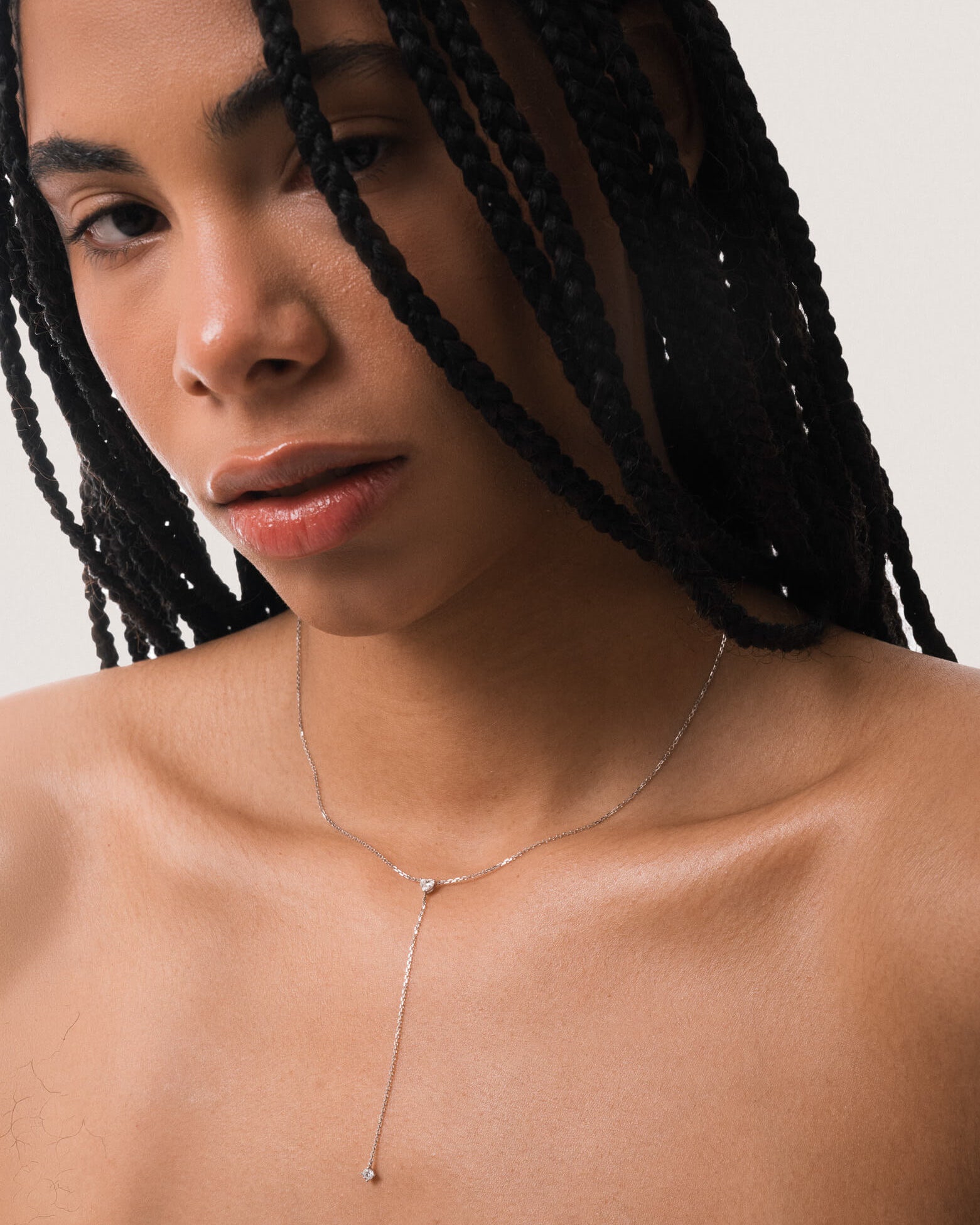 Model wearing the Amara heart diamond tie necklace in solid white gold by Anate, worn on model, portrait shot