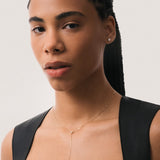 Model wearing the Amara heart diamond tie necklace in solid yellow gold by Anate, worn on model, portrait shot
