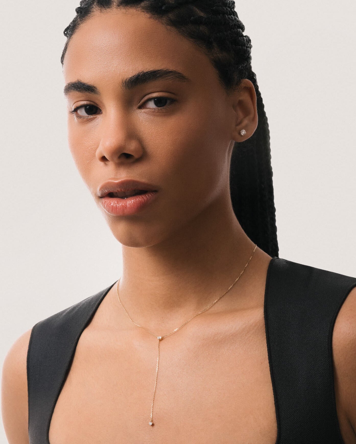 Model wearing the Amara heart diamond tie necklace in solid yellow gold by Anate, worn on model, portrait shot