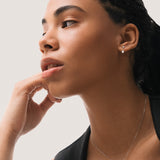 Model wearing the Elin oval diamond ear jacket earrings in solid white gold by Anate, worn on model, portrait shot variant--0.25ct