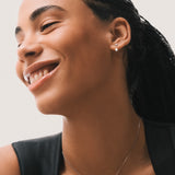 Model wearing the Elin oval diamond ear jacket earrings in solid white gold by Anate, worn on model, portrait shot variant--0.25ct