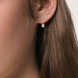 Model wearing the Elin oval diamond ear jacket earrings in solid yellow gold by Anate, worn on ear variant--0.50ct