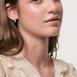 Model wearing the Elin oval diamond ear jacket earrings in solid yellow gold by Anate, worn on model, side profile variant--0.25ct