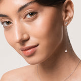 Model wearing the Talya pear diamond drop earrings in solid white gold by Anate, worn on model, portrait shot