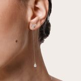 Model wearing the Talya pear diamond drop earrings in solid white gold by Anate, worn on model, side profile