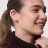 Model wearing the Talya pear diamond drop earrings in solid yellow gold by Anate, worn on ear