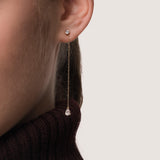 Model wearing the Talya pear diamond drop earrings in solid yellow gold by Anate, worn on ear