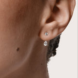 Model wearing the Nara pear diamond ear jacket earrings in solid white gold by Anate, worn on ear variant--0.25ct