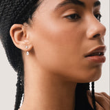 Model wearing the Nara pear diamond ear jacket earrings in solid white gold by Anate, worn on model, portrait shot variant--0.50ct