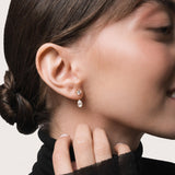Model wearing the Nara pear diamond ear jacket earrings in solid yellow gold by Anate, worn on ear variant--0.50ct