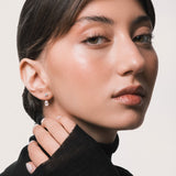 Model wearing the Nara pear diamond ear jacket earrings in solid yellow gold by Anate, worn on ear variant--0.50ct