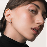 Model wearing the Nara pear diamond ear jacket earrings in solid yellow gold by Anate, worn on model, portrait shot variant--0.50ct