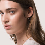 Model wearing the Nara pear diamond ear jacket earrings in solid yellow gold by Anate, worn on model, side profile variant--0.25ct