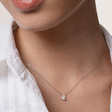 Model wearing the Liora pear diamond pendant in solid white gold by Anate, worn on neck