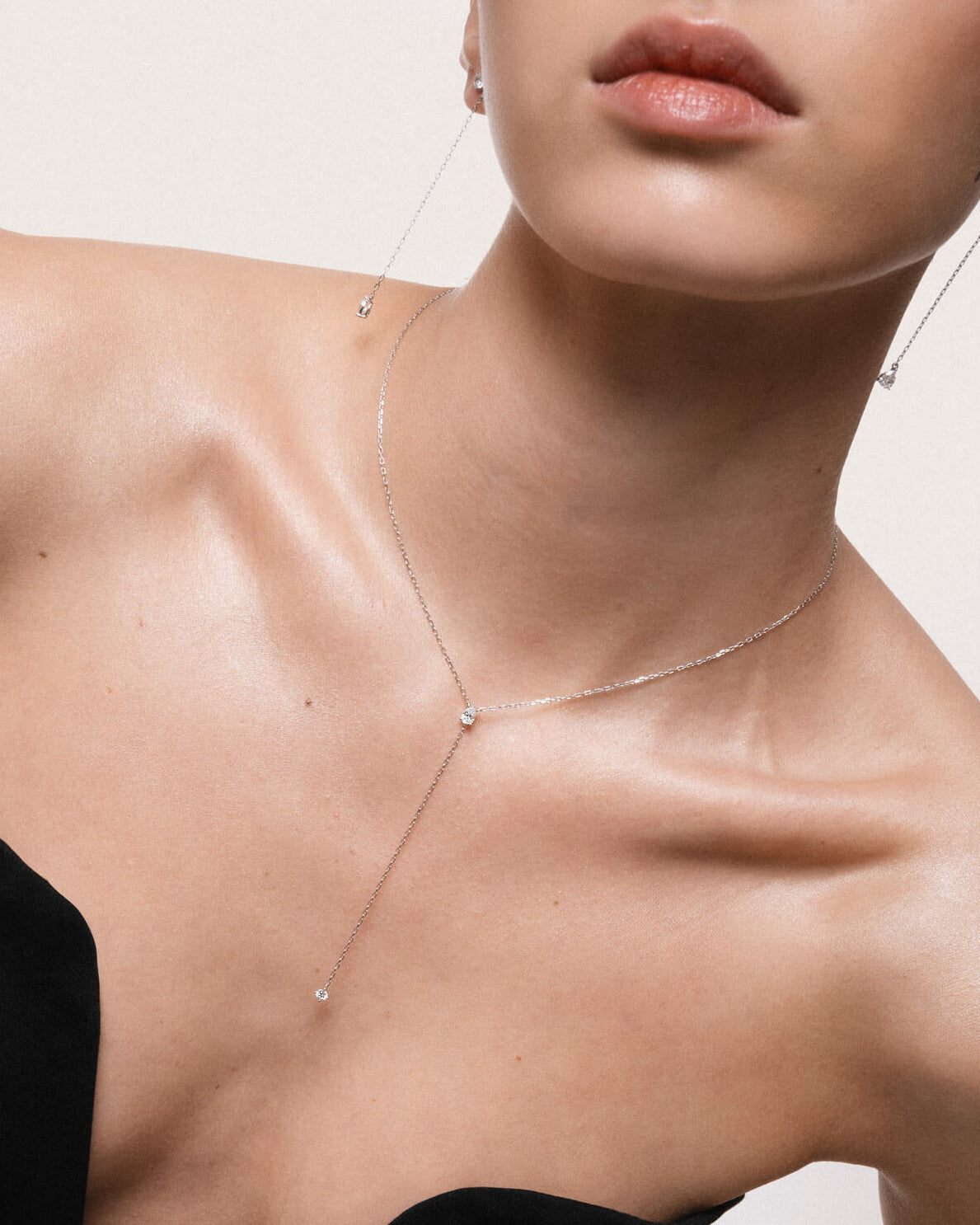 Kaia pear diamond tie necklace in 10K solid white gold styled close-up on model