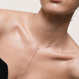 Kaia pear diamond tie necklace in 10K solid white gold styled close-up on model