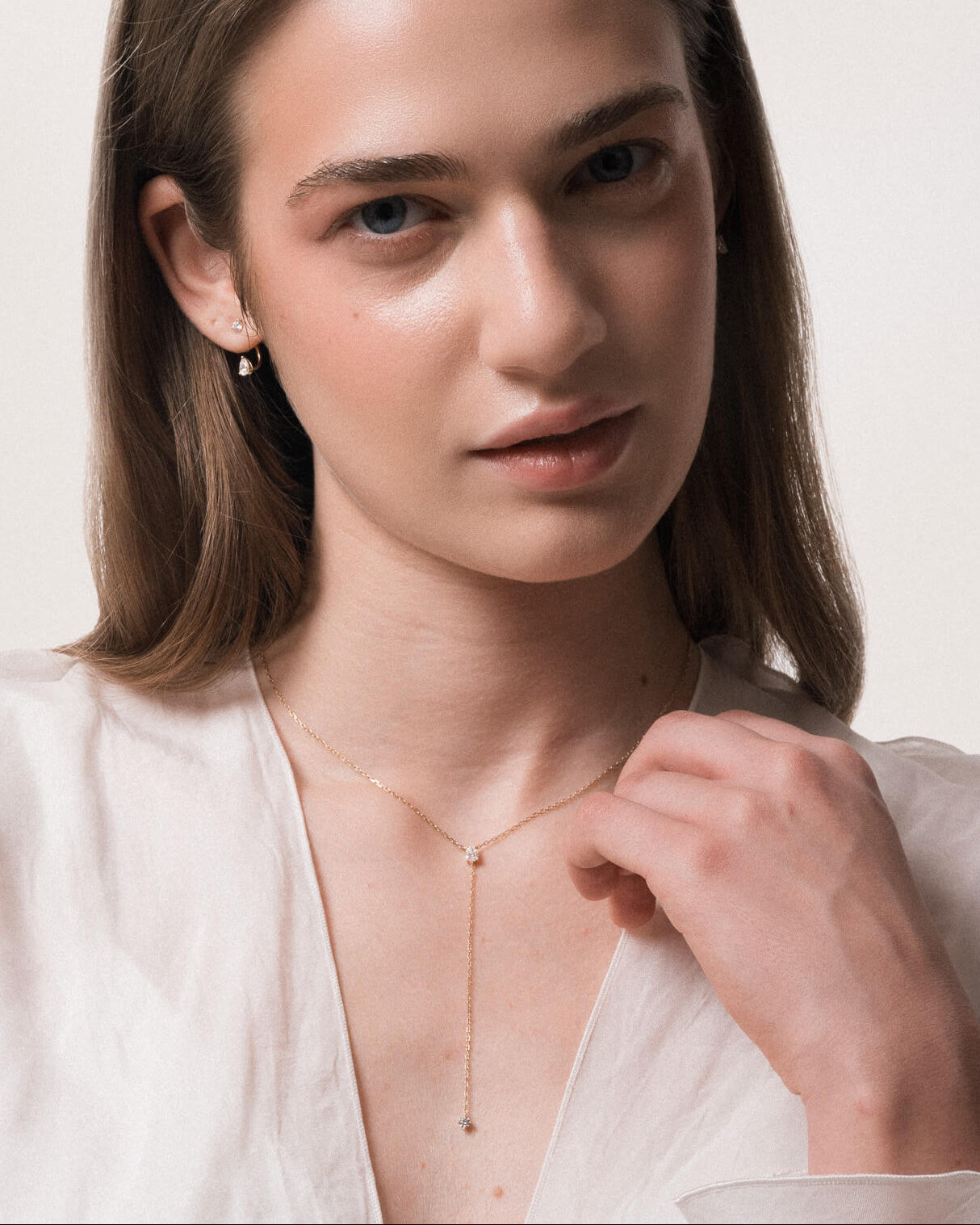 Model wearing the Kaia pear diamond tie necklace in solid yellow gold by Anate, worn on model, portrait shot
