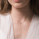 Model wearing the Kaia pear diamond tie necklace in solid yellow gold by Anate, worn on neck